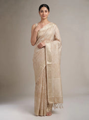 Front view of elegant beige linen woven saree with model’s right hand near her chest