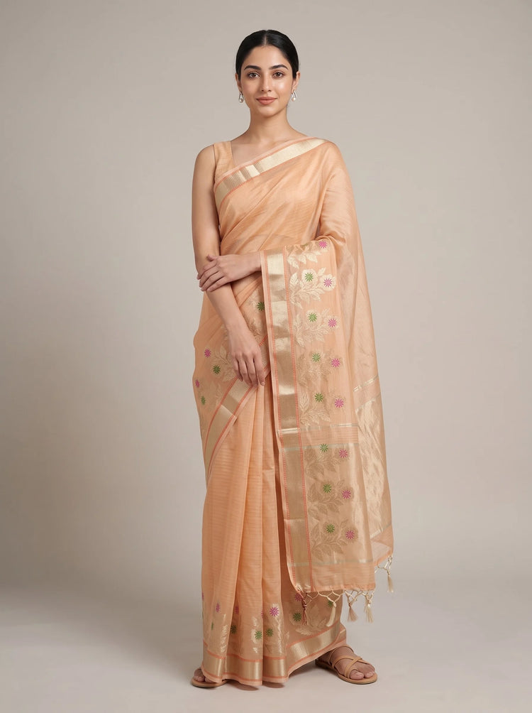 Front view of orange Kota tissue woven border saree with the model’s right hand near her chest, highlighting the woven border and pallu