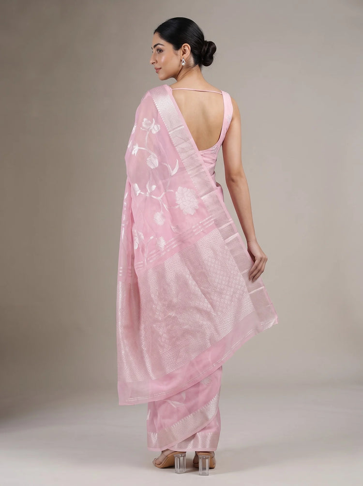 Back view of elegant pink cotton woven saree showing the blouse, saree drape and traditional woven border