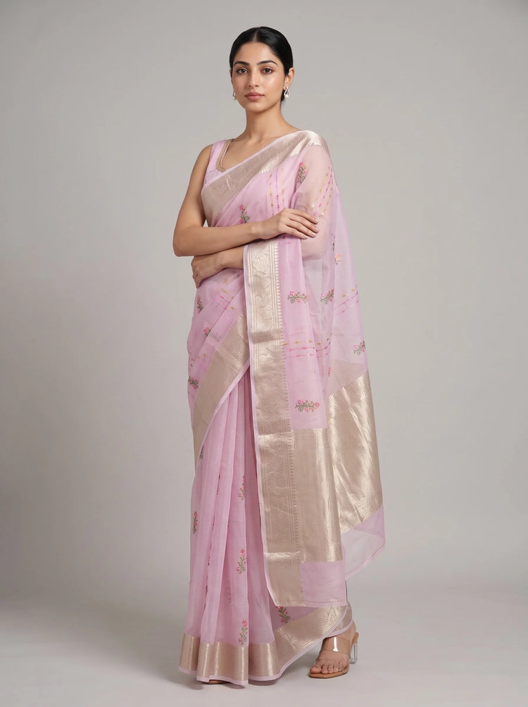 Front view of lilac purple Munga Kota embroidered saree with the model’s right hand near her chest, highlighting the floral embroidery and border