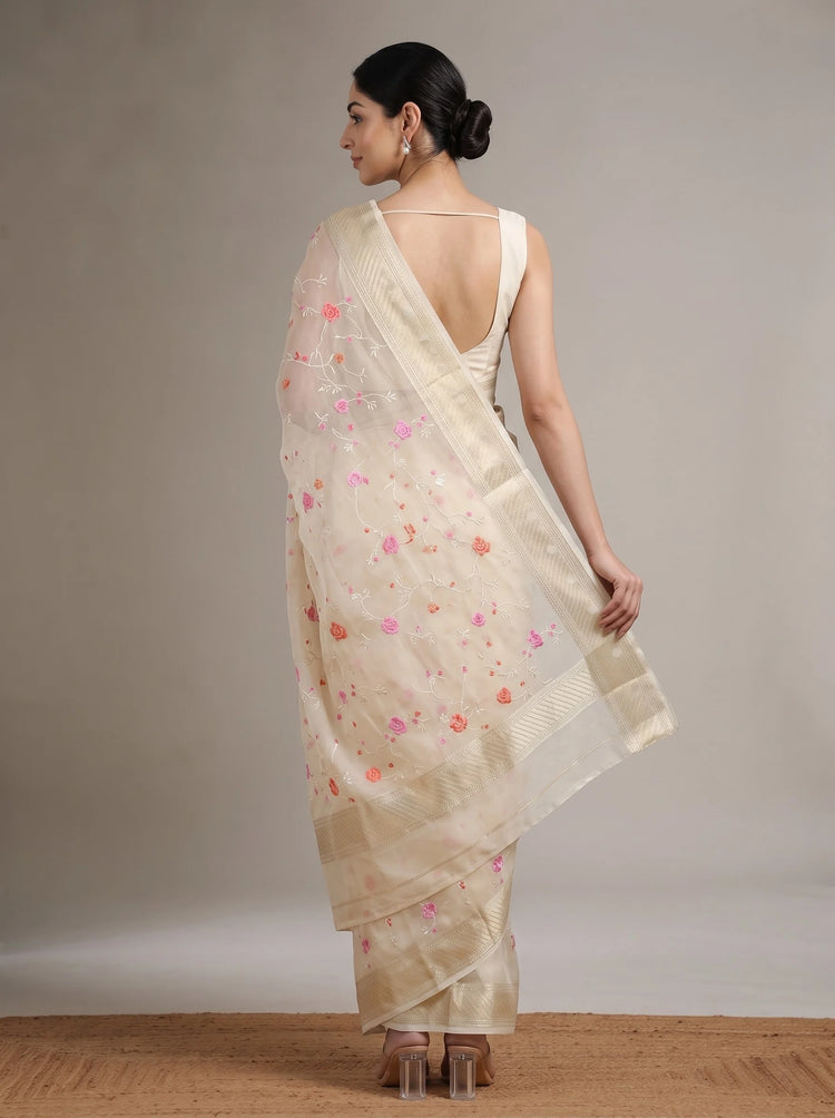 Back view of cream Munga Kota cotton Banarasi embroidered saree showing the elegant drape, floral motifs and decorative border