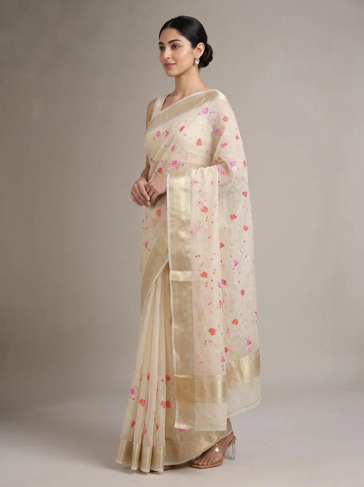 Side view of cream Munga Kota cotton Banarasi embroidered saree showing the flowing drape, embroidered details and ornate border