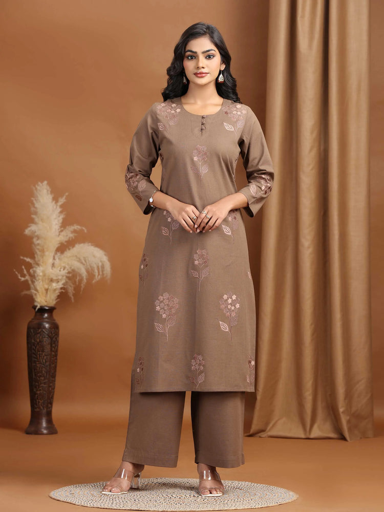 Woman wearing a brown kurta with floral embroidery against a brown background